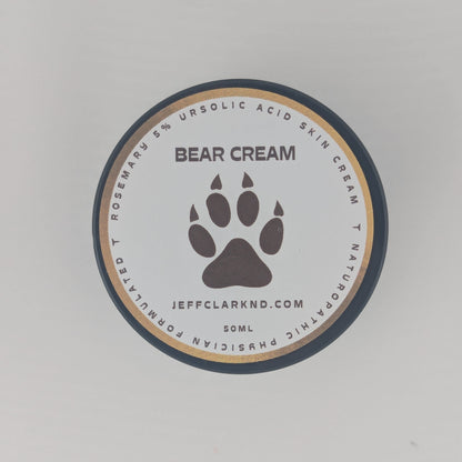 Bear Cream container with paw print design on a light gray background