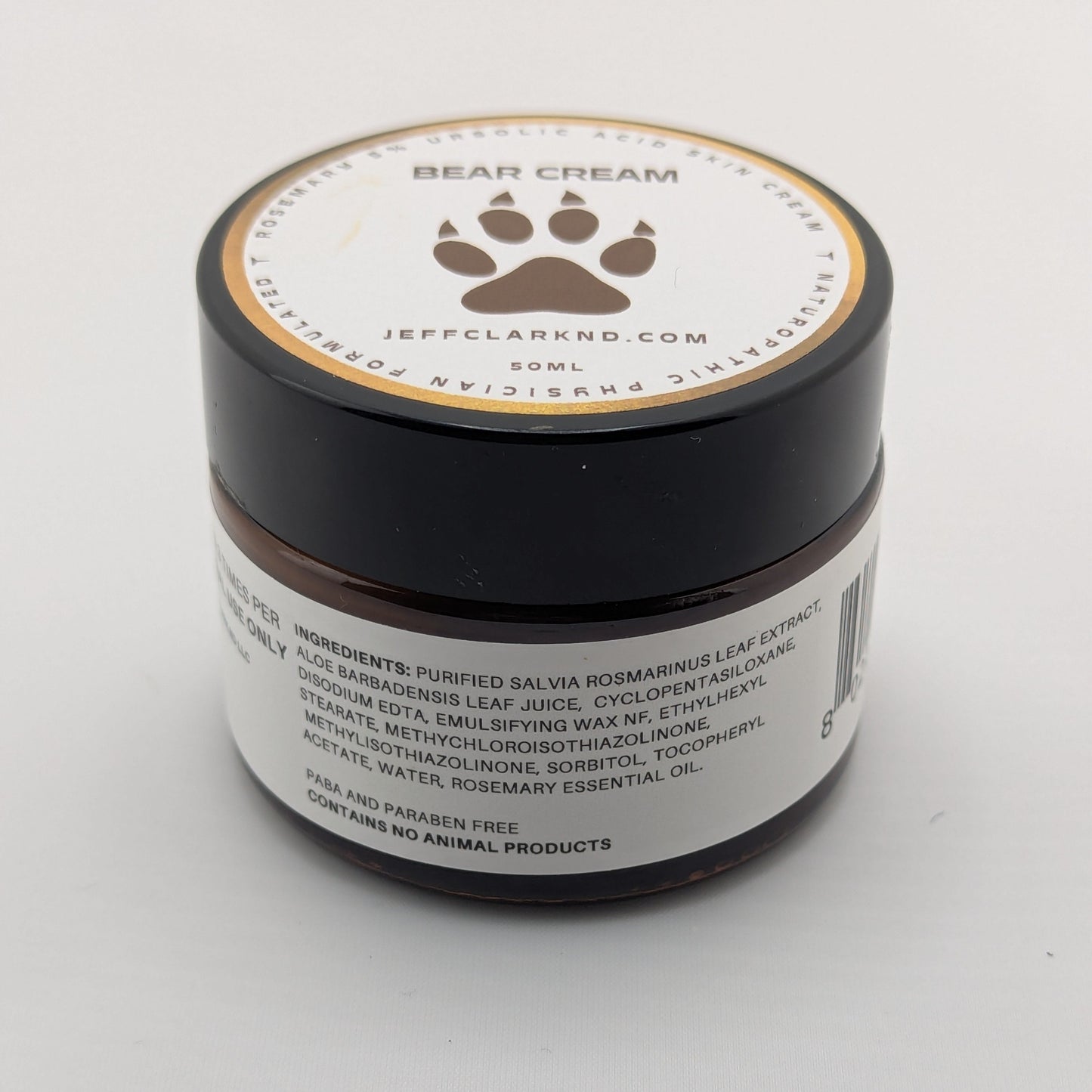 Jar of bear cream with a paw print logo on a white background
