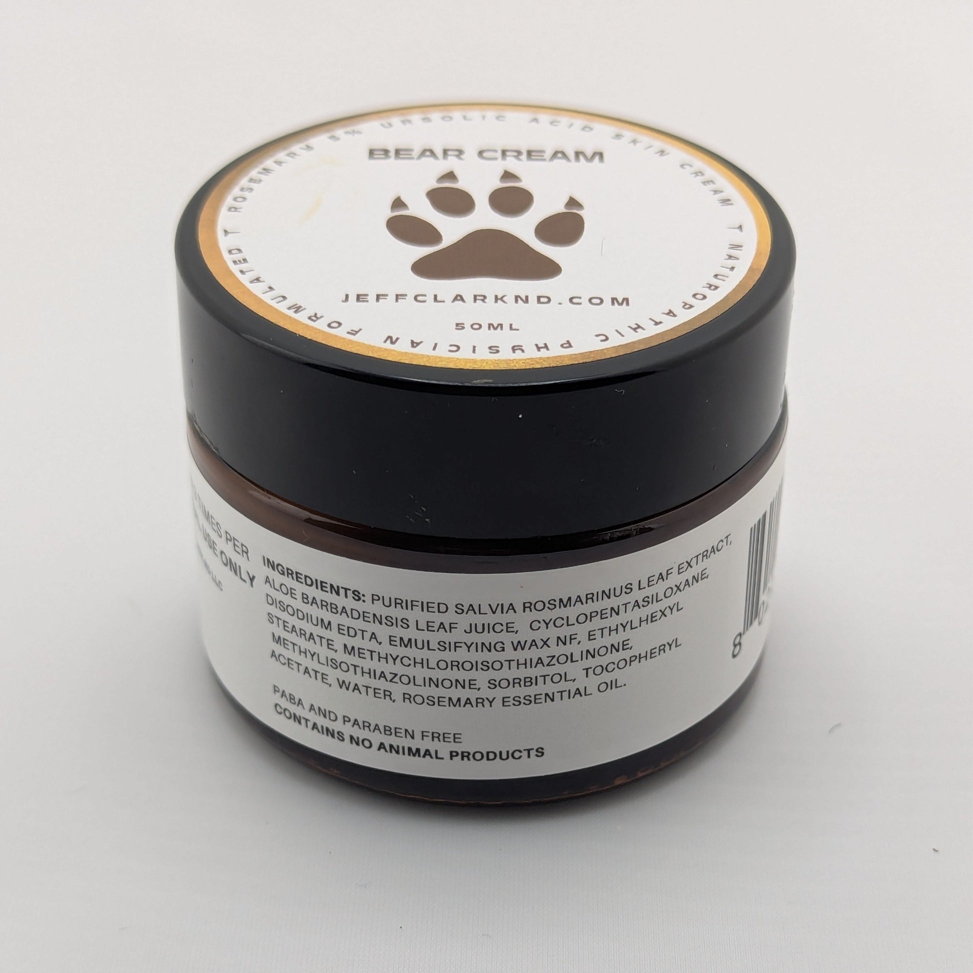 Jar of bear cream with a paw print logo on a white background