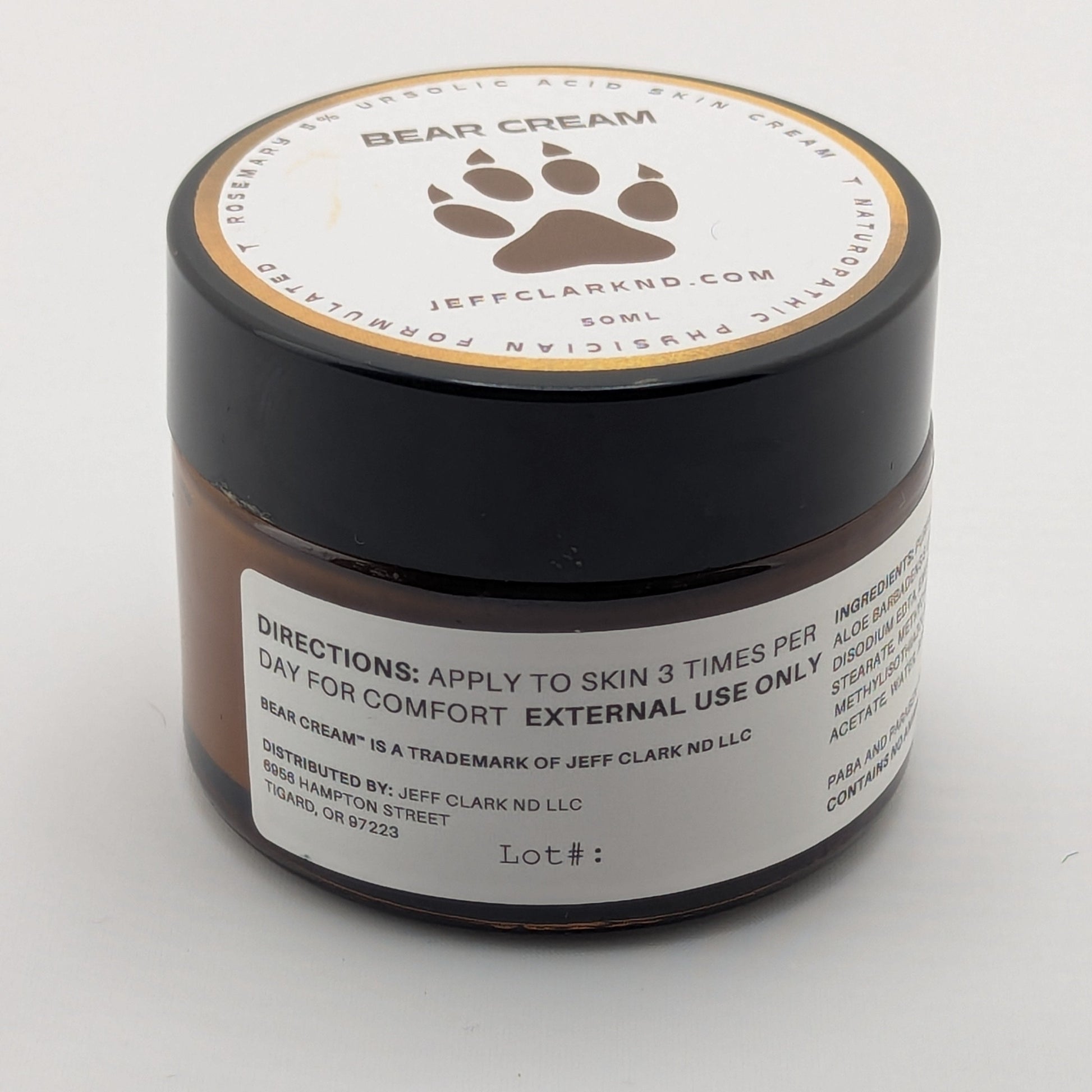 Jar of bear cream with a paw print design on a white background